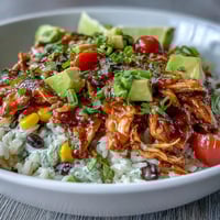 Colorful salsa chicken bowls with shredded chicken, rice, black beans, and fresh toppings for a quick, satisfying meal.  